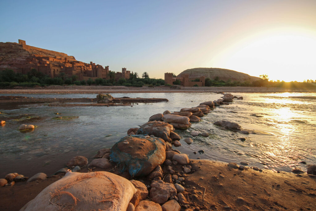 Sunrise over a makeshift bridge leading to the ancient ksar of Ait Benhaddou