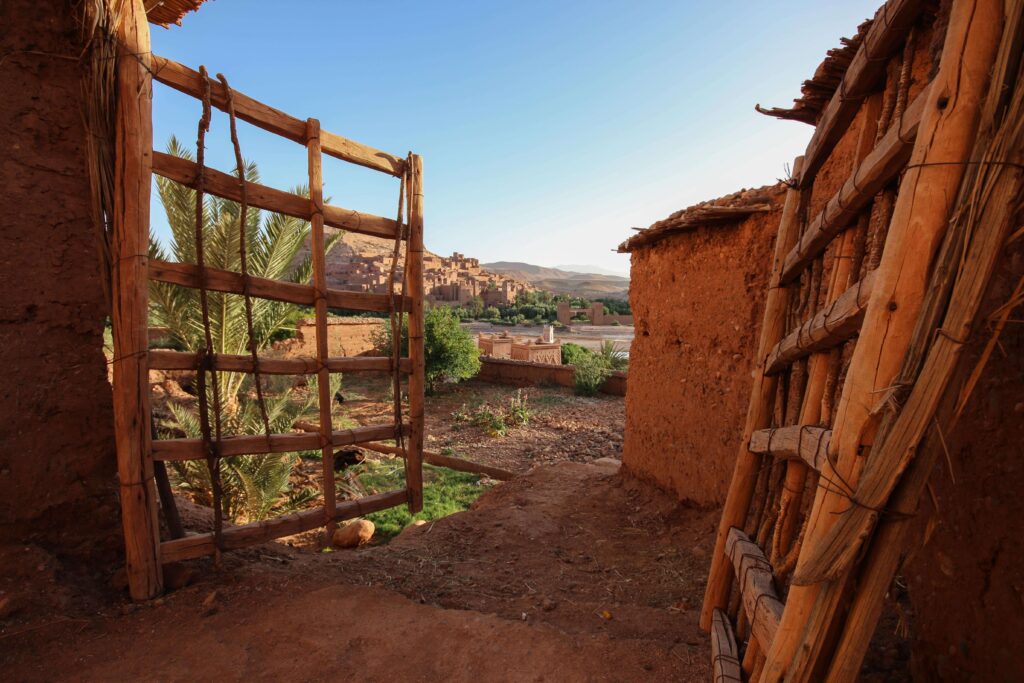View through a wooden gate toward the ancient ksar of Ait Benhaddou