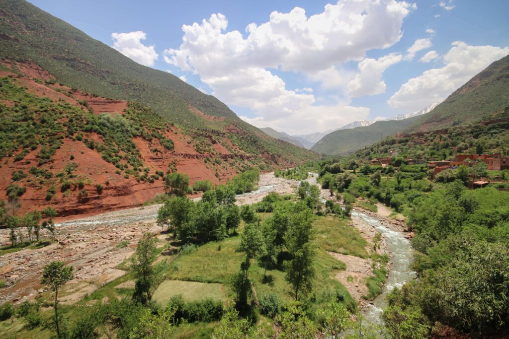 Travel guide to Imlil: A river rushes through a valley in the Atlas Mountains