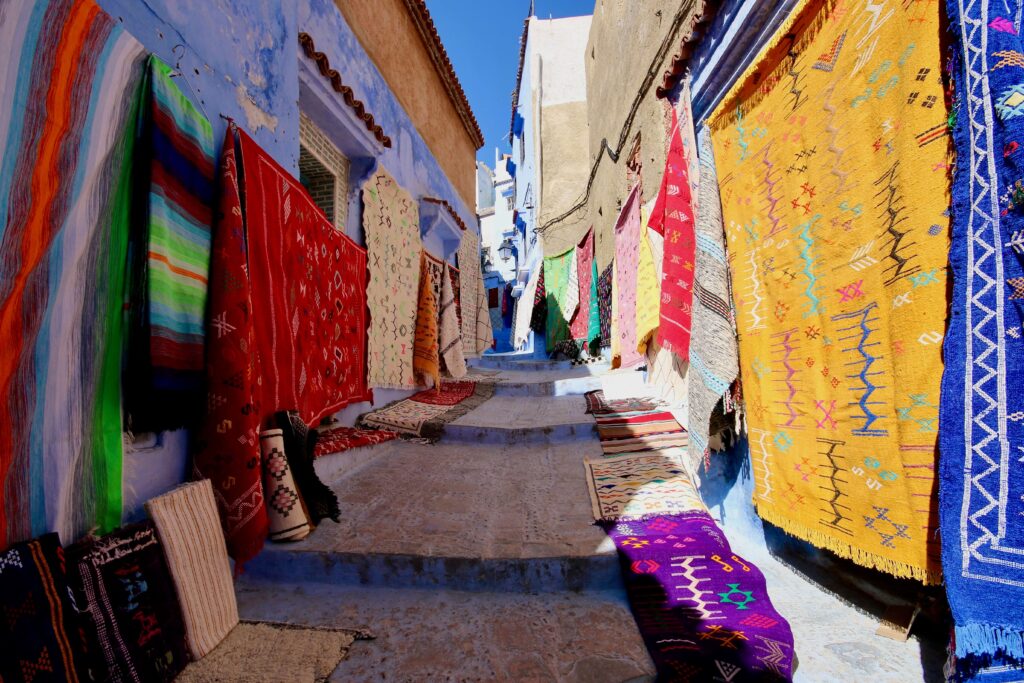 Best things to do in Chefchaouen - Colourful textiles for sale in one of Chefchaouen's blue streets