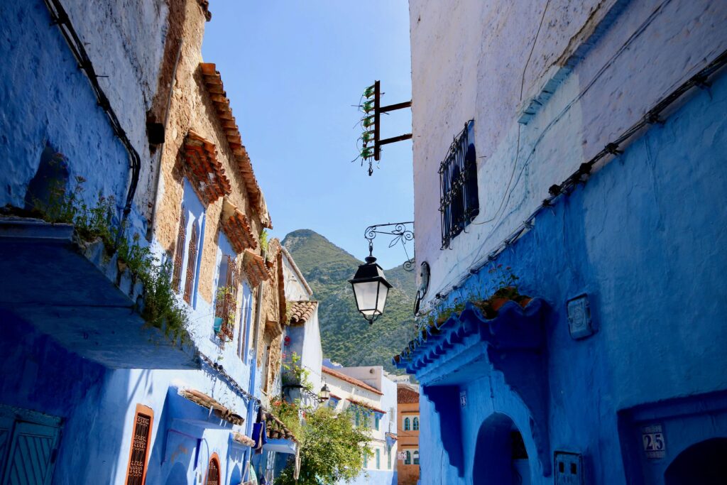Best travel insurance for Morocco - Blue-hued buildings backed by the Rif Mountains in Chefchaouen