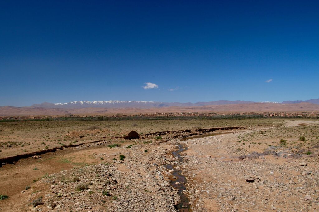 Travel guide to Ouarzazate - Dramatic desert scenery near Ouarzazate backed by the snow-capped Atlas Mountains