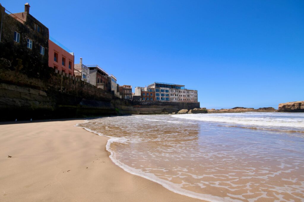 Best things to do in Essaouira - Water laps at the base of Essaouira's ancient medina walls at Plage Akskis