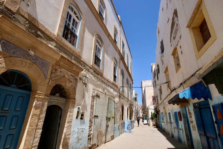 Blue and white buildings frame a street in Essaouira - a popular destination for Marrakech day trips