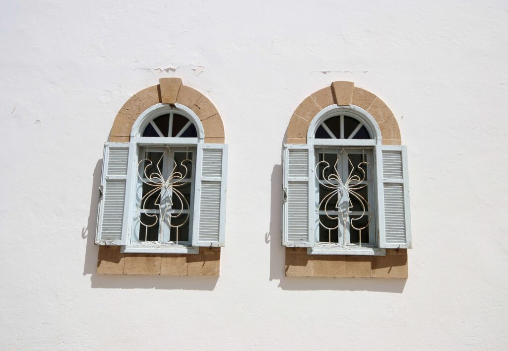 Best things to do in EssaouiraBlue shuttered windows on a whitewashed building in Essaouira