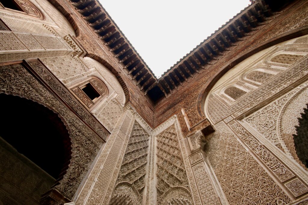 Is October a good time to visit Fes? Intricate decorations on a wall in the Al Attarine Madrasa in Fes, Morocco