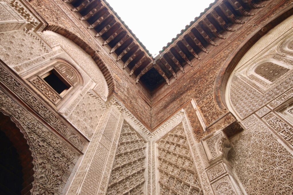 Best things to do in Fes in April - Intricate decorations within the courtyard of Al Attarine Madrasa in Fes