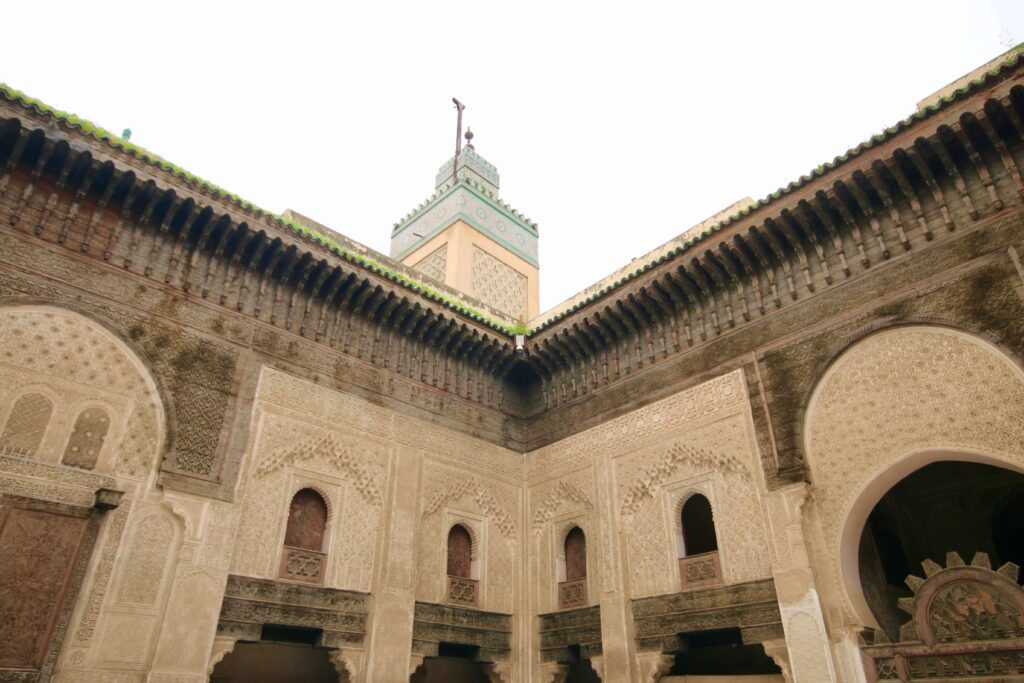 A minaret rises about the Bou Inania Madrasa in Fes, Morocco