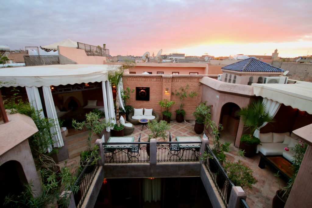 Best places to stay in Marrakech - Sunset from a rooftop terrace at a Marrakech riad