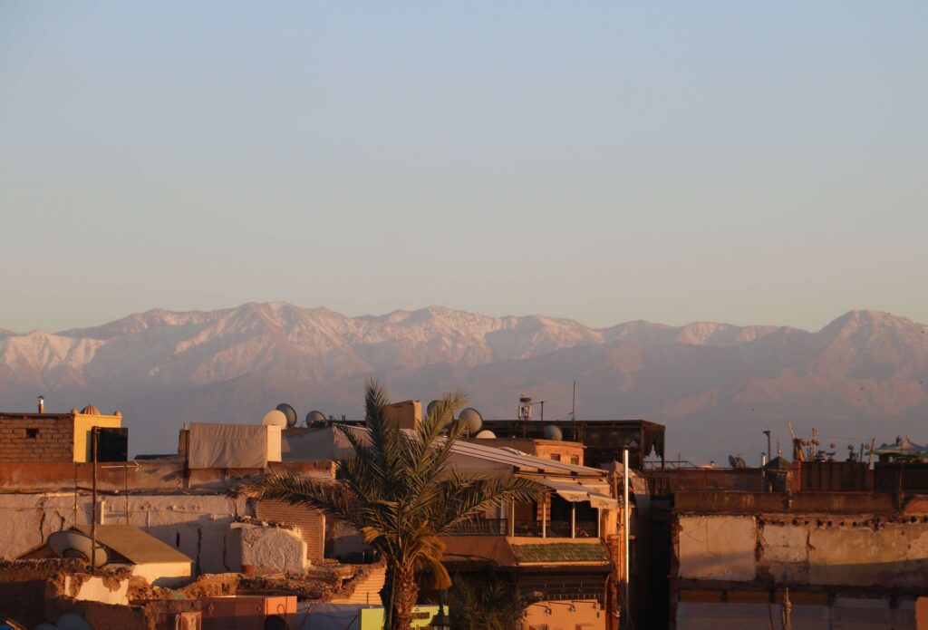 Looking across the rooftops of the Marrakech medina toward the snow-capped Atlas Mountains