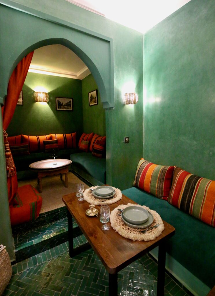 A elegantly decorated green lounge at a luxury riad in Marrakech