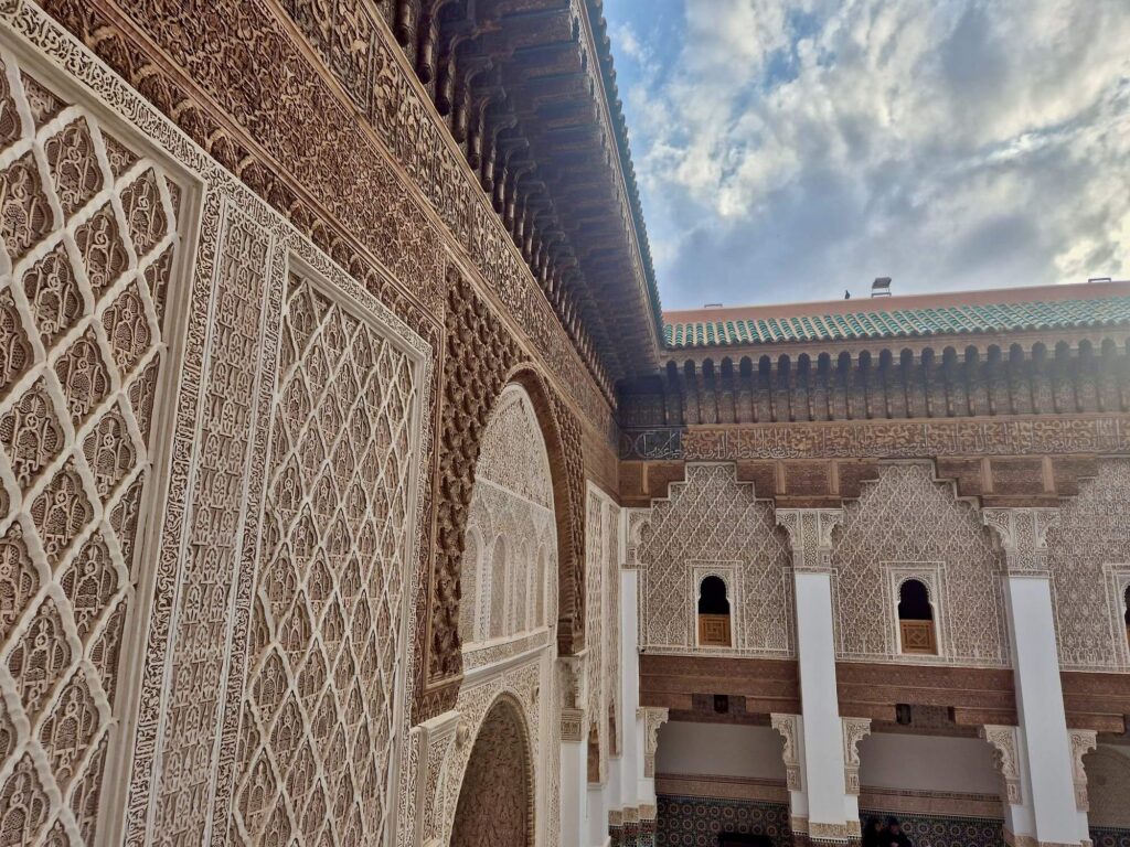 Admiring the intricately decorated walls of the Ben Youssef Madrasa in Marrakech