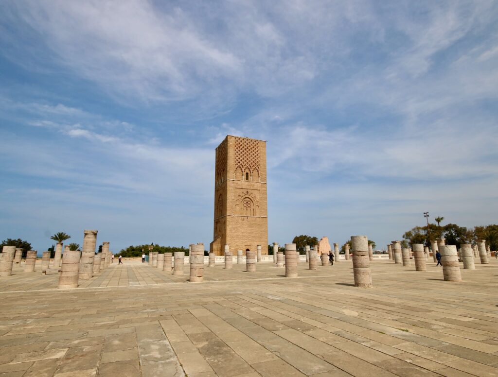 The unfinished Hassan Tower surrounded by foundations of an intended mosque during a one day Rabat itinerary