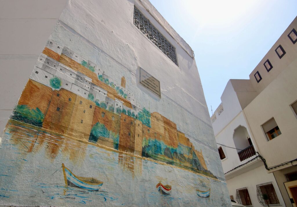 A mural adorns a whitewashed building in the medina of Salé