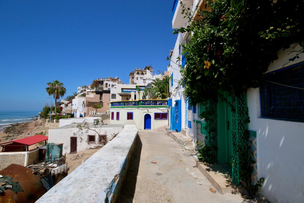 Travel guide to Agadir - Colourful houses line the waterfront of Taghazout, Morocco
