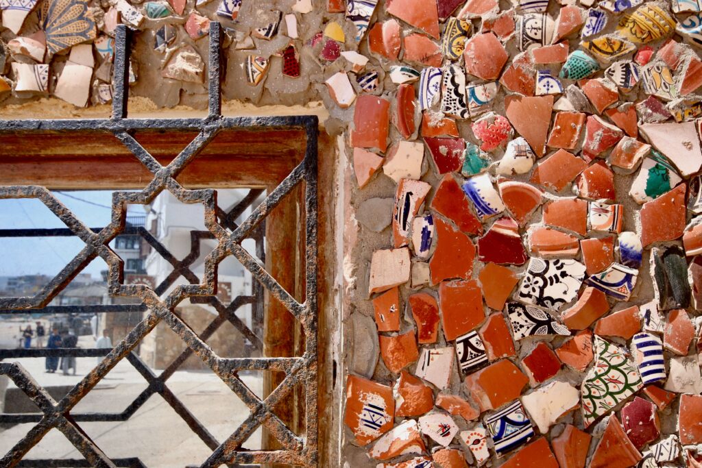 Broken ceramics decorate a wall in Agadir - is October a good time to visit?