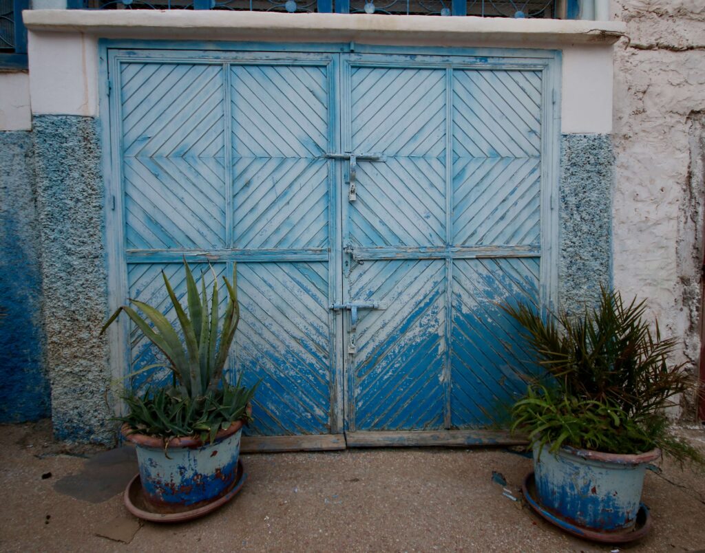A blue garage door in a village near Agadir