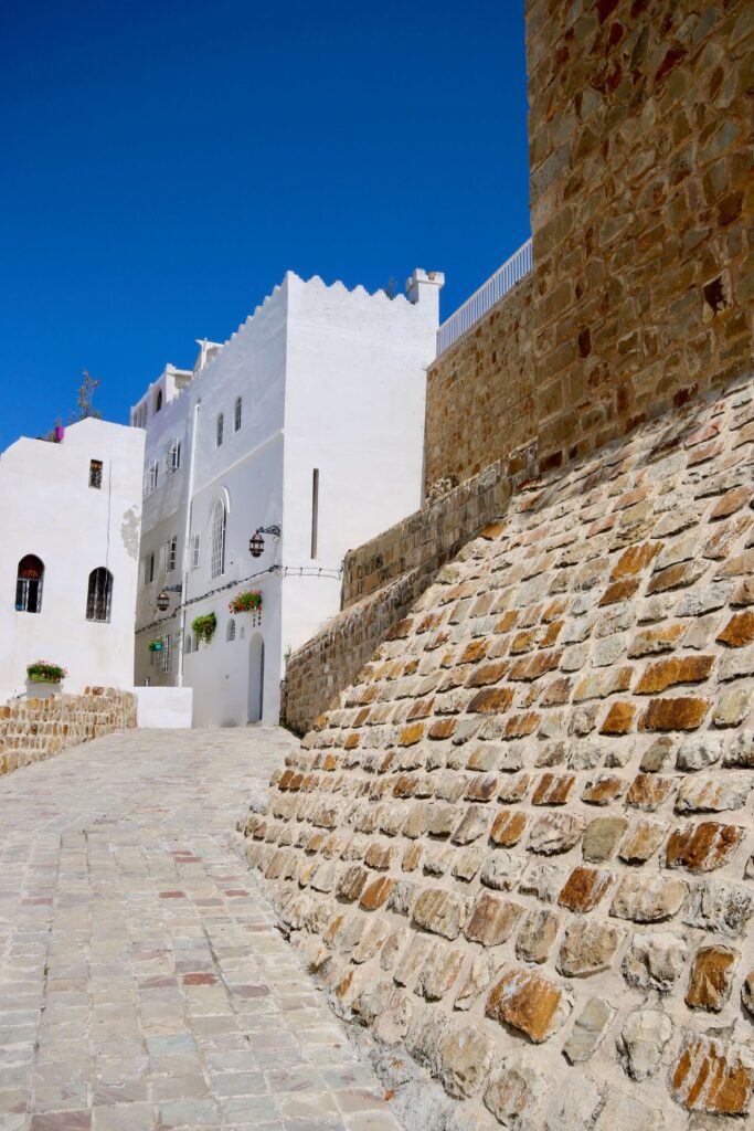 A stone building against the whitewashed architecture of Tangier's Kasbah district