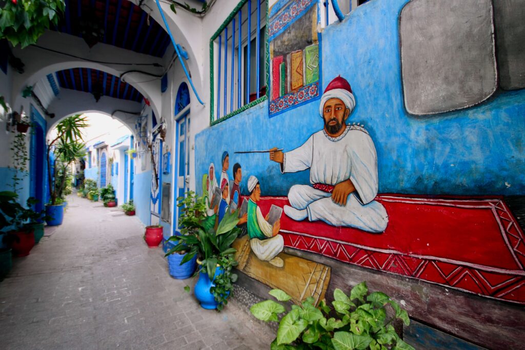 Best things to do in Tangier - A mural adorns a plant-filled street in the Tangier medina