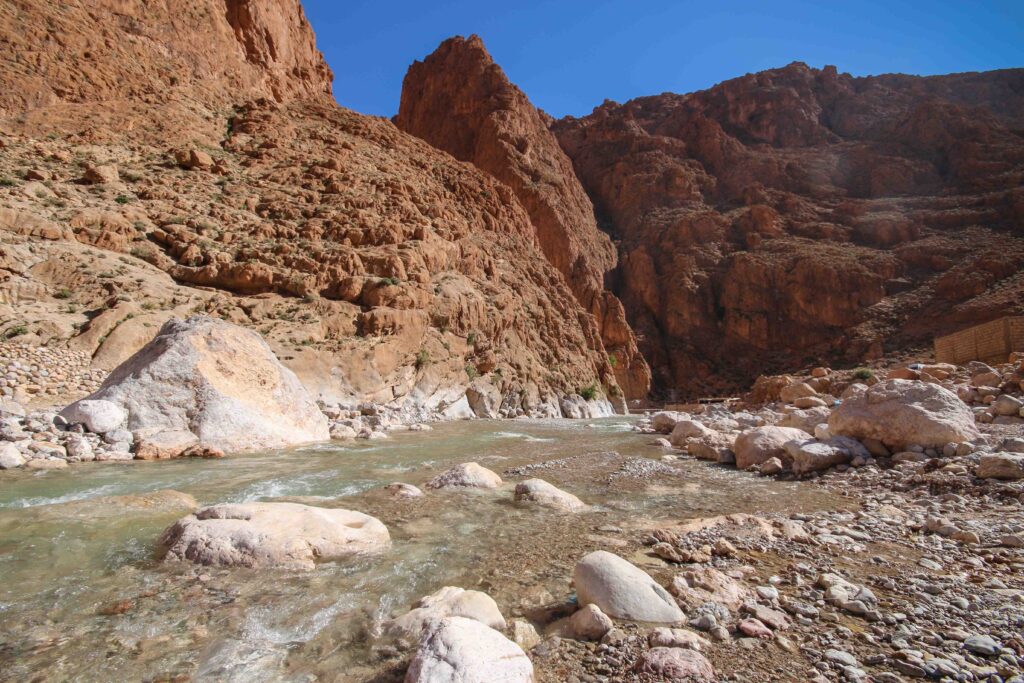 A river winds through a rocky gorge in the foothills of the Atlas Mountains