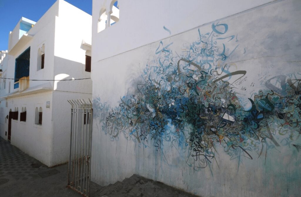 Best things to do in Asilah - Street art decorates a whitewashed wall in Asilah on the Atlantic coast of Morocco