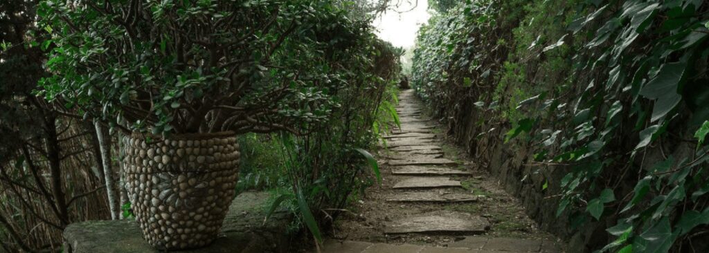 A garden path leads through the grounds of Aux 3 Portes, one of the best hotels in Tangier with a pool