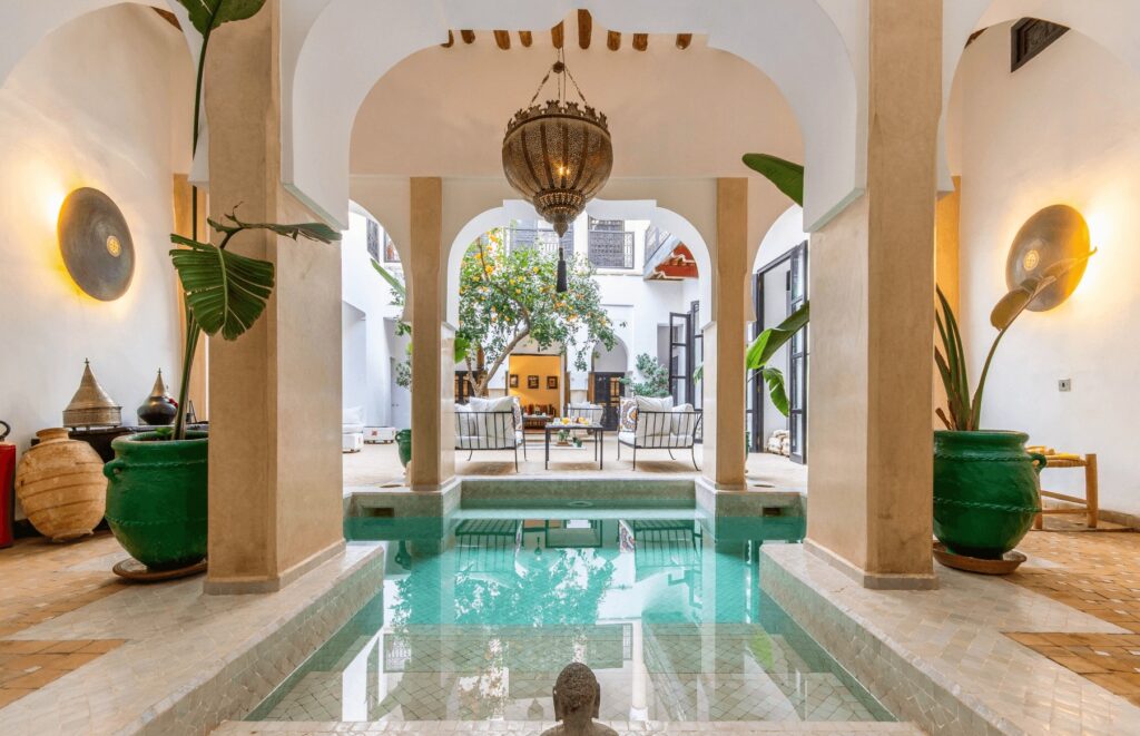 A courtyard pool at a Marrakech riad with a fireplace
