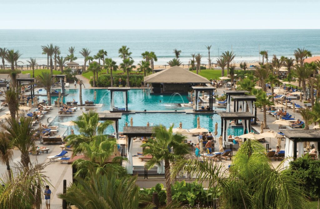 Palm trees surround the outdoor pools at Hotel Riu Palace Tikida, one of the best all-inclusive hotels in Agadir