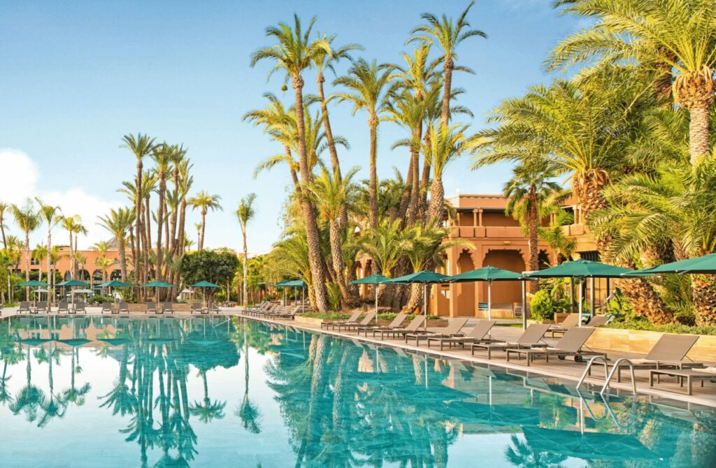 Palm trees reflected in a pool at one of the best adults-only hotels in Marrakech for 2025