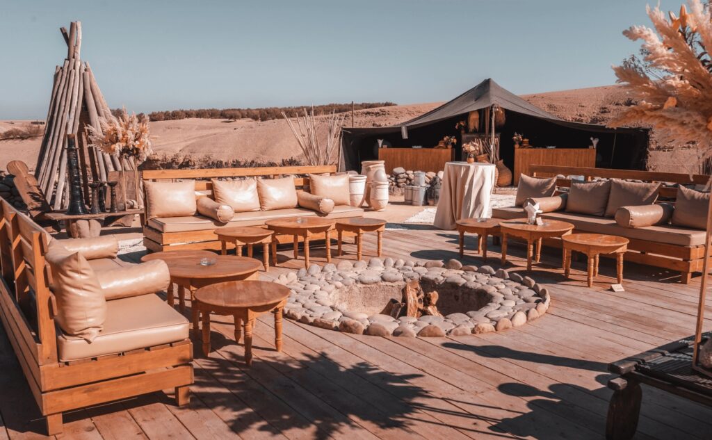 An outdoor seating area and fireplace at one of the best luxury camps in Agafay Desert