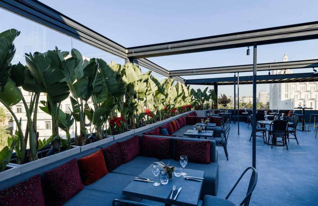 Greenery frames the dining terrace at JM Suites Hotel in Casablanca 