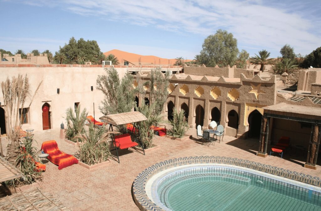 An elevated view of a courtyard swimming pool at one of the best riads in Merzouga