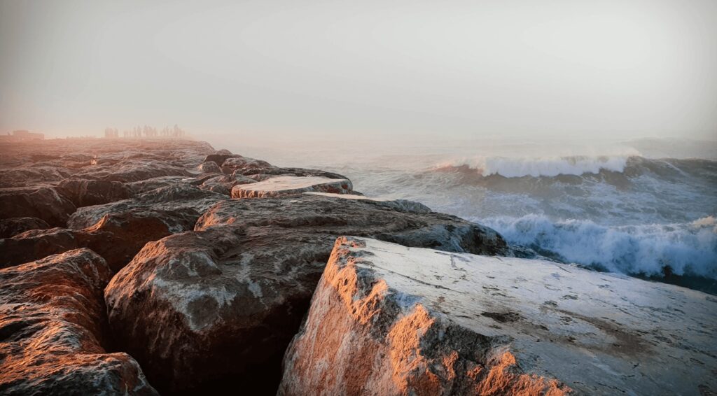 Travel guide to Kenitra - Waves crash along a rocky shore in Kenitra, Morocco