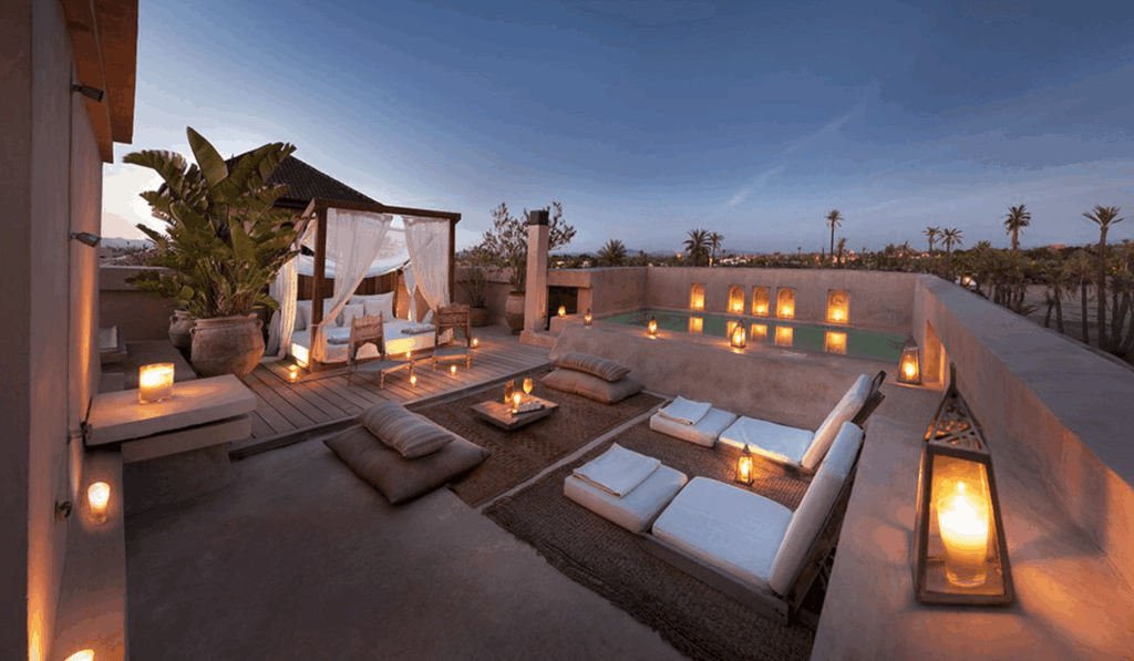 Lanterns illuminate a rooftop terrace with plunge pool at Ksar Char Bagh, one of the best Marrakech hotels with a hammam