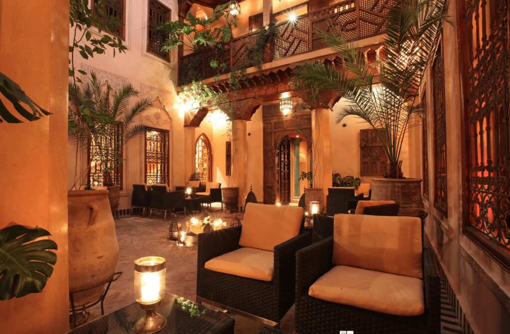 Lanterns illuminate a central patio at one of the best Marrakech hotels with a fireplace