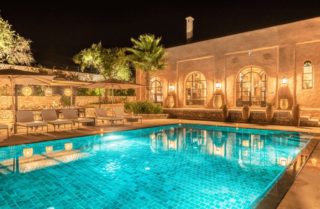 An illuminated swimming pool at a villa near Essaouira