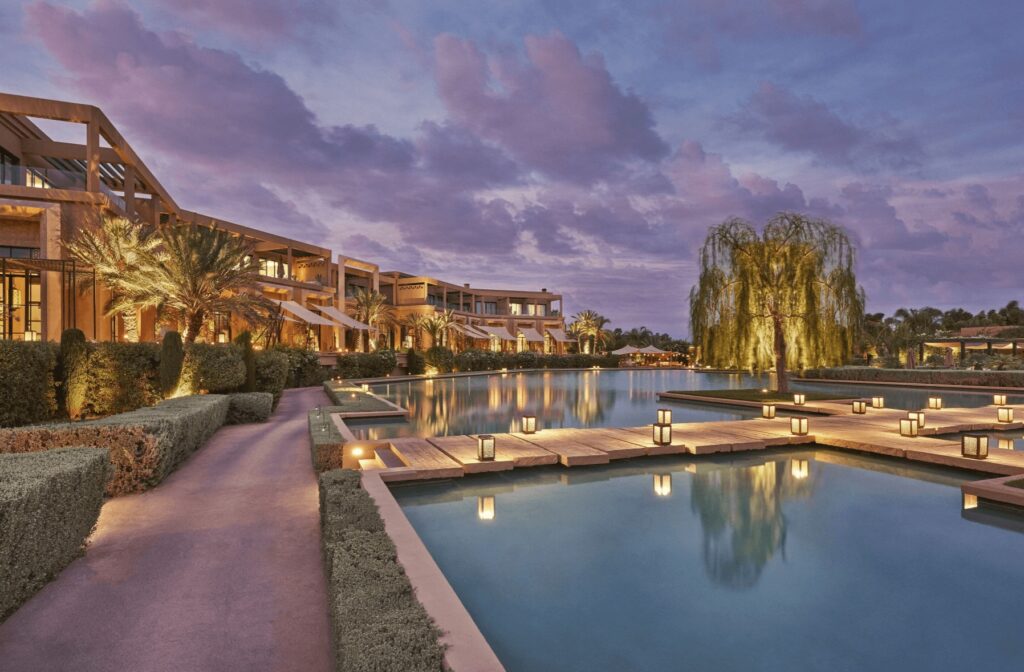 Lanterns illuminate a swimming pool at one of the best golf hotels in Marrakech