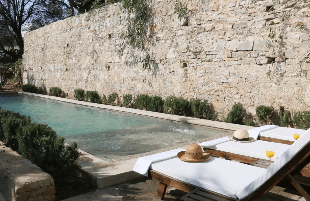 Sun loungers beside the swimming pool at Mimi Calpe, a boutique hotel in Tangier