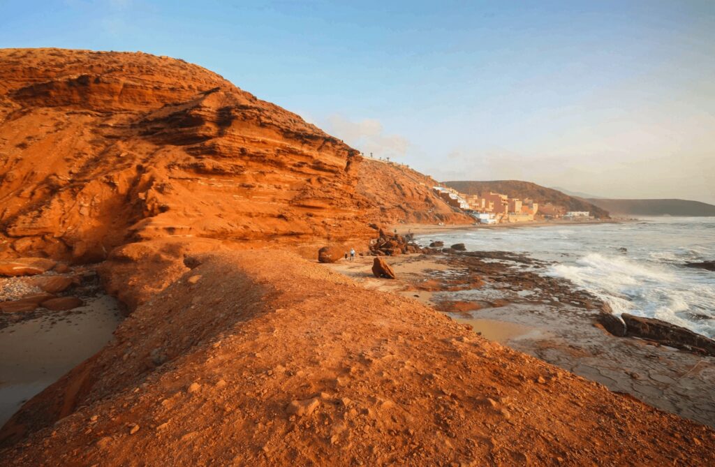 Travel guide to Mirleft: Sunset illuminates the ochre cliffs of Mirleft