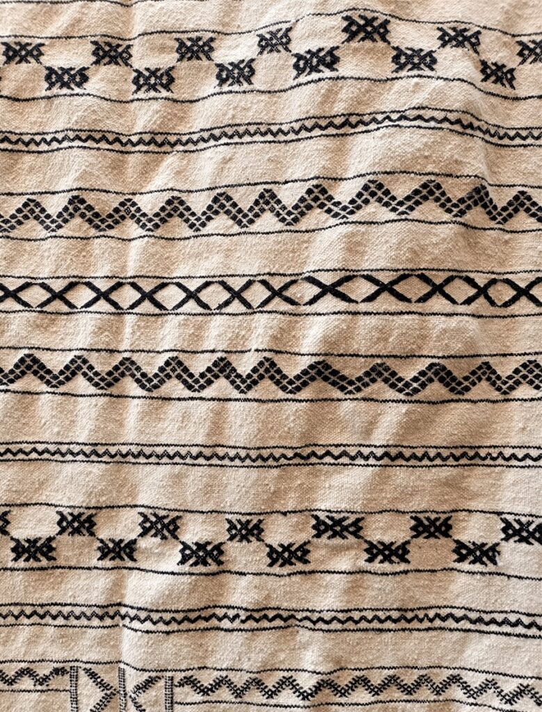A traditional Amazigh rug with a black and white design