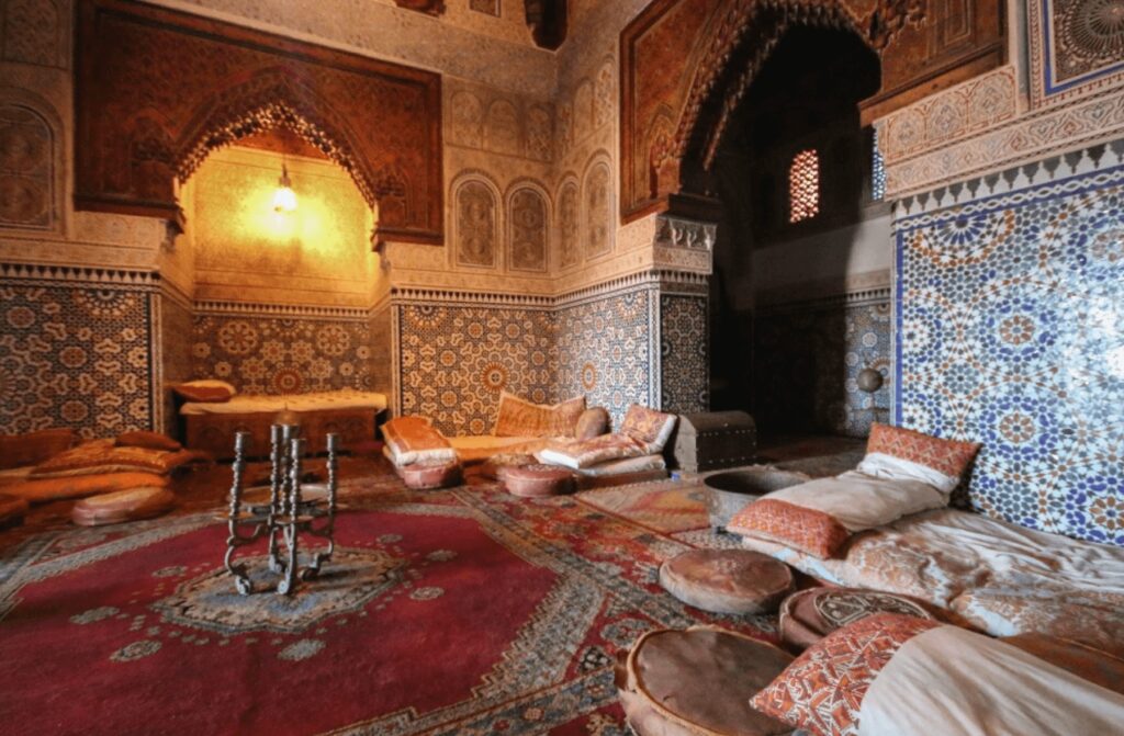 Moroccan rugs cover a floor in a beautifully decorated riad