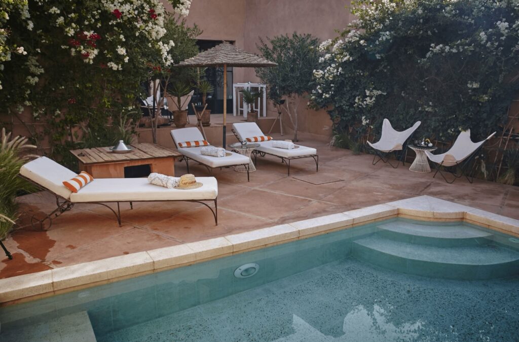 Best places to stay in Ait Benhaddou - Sun loungers beside a swimming pool at Riad Caravane in Ait Benhaddou