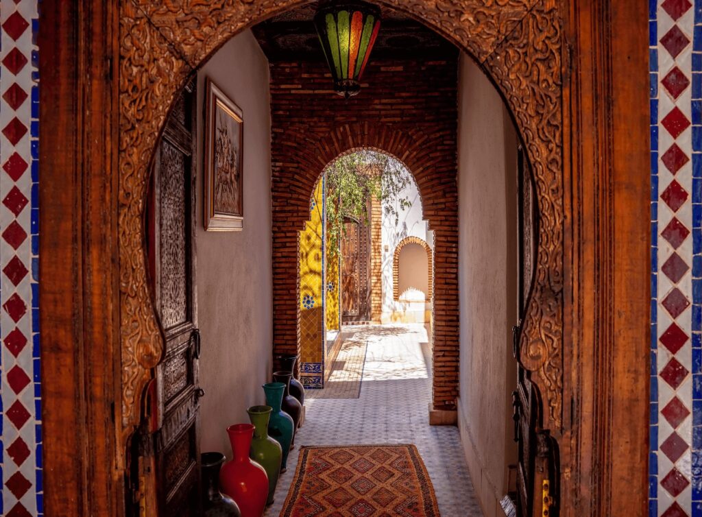 A decorative arch leads to a hallway at Riad Cle de Sol in Ourika, Morocco