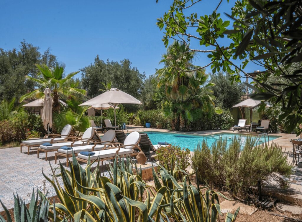 A swimming pool and loungers at Riad Clé De Sol, one of the best places to stay in Ourika Valley