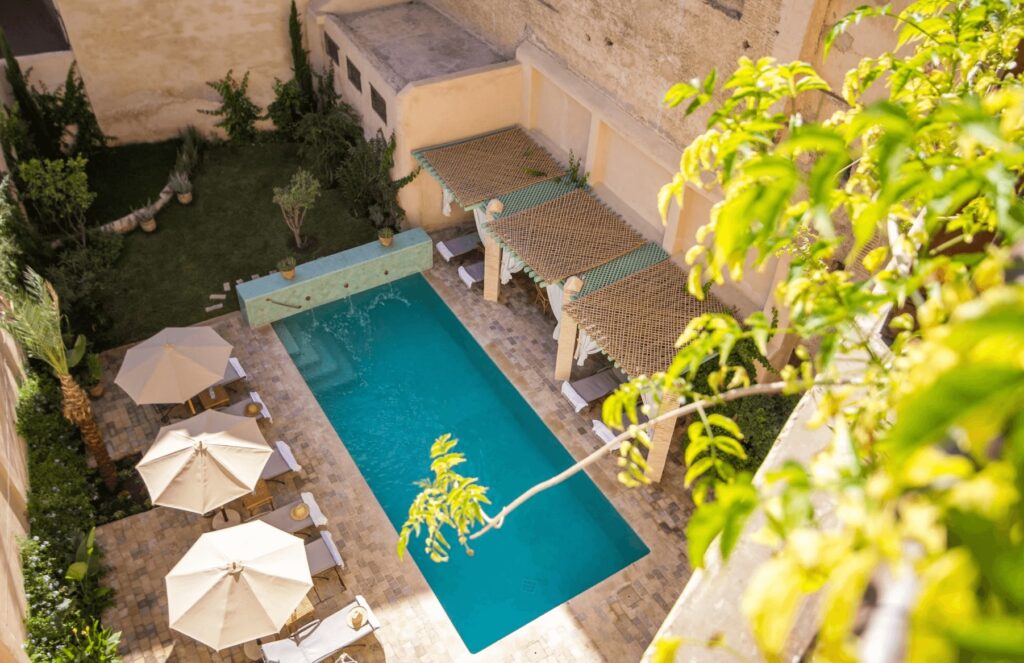 An elevated view of the swimming pool at Riad Laaroussa, one of the best hotels in Fes with a hammam