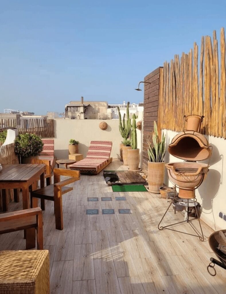 Cacti and sun loungers on the rooftop terrace of a highly-rated riad in Essaouira