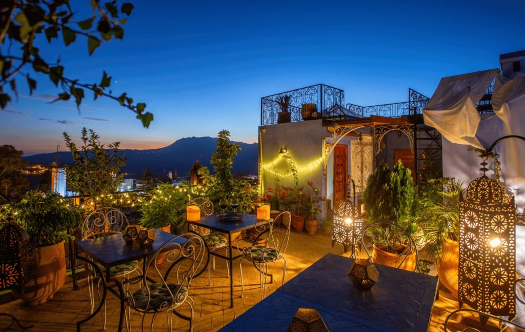 Traditional lanterns illuminate the rooftop terrace of Riad Nila in Chefchaouen 