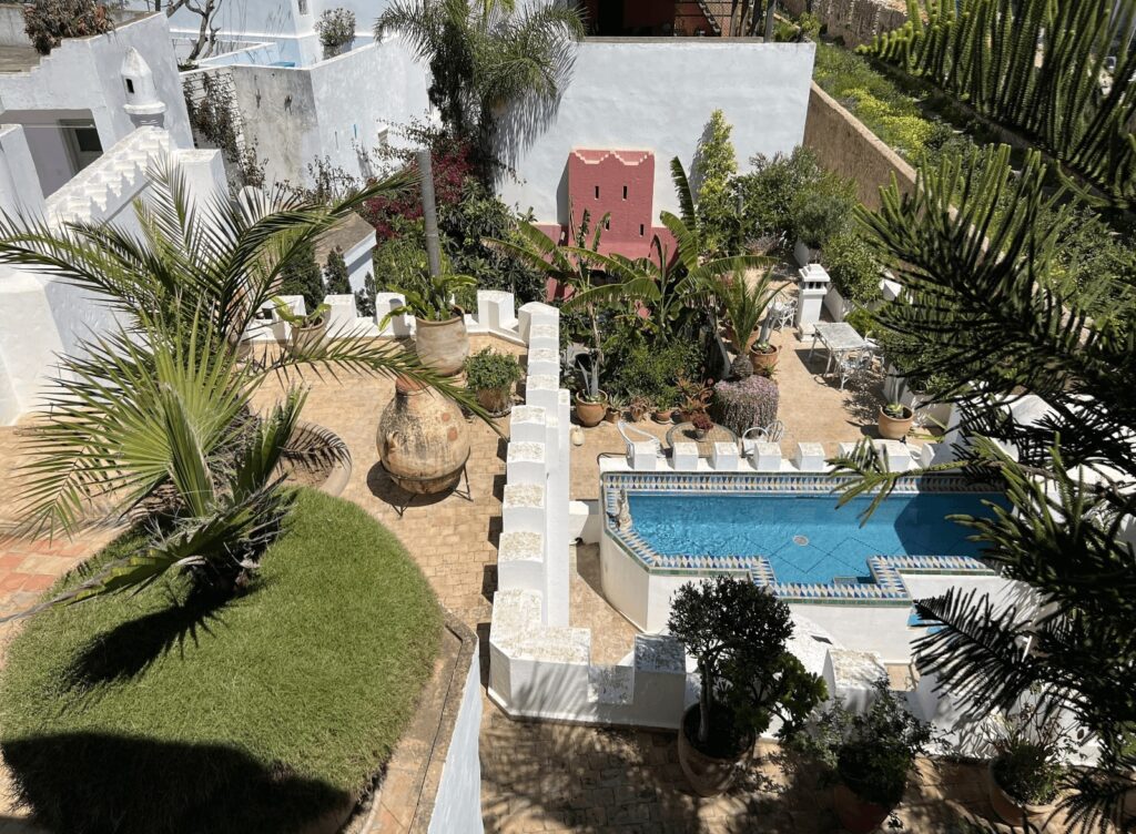 An elevated view of the swimming pool and garden at Riad Oasis d'Asilah, one of the best hotels in Asilah