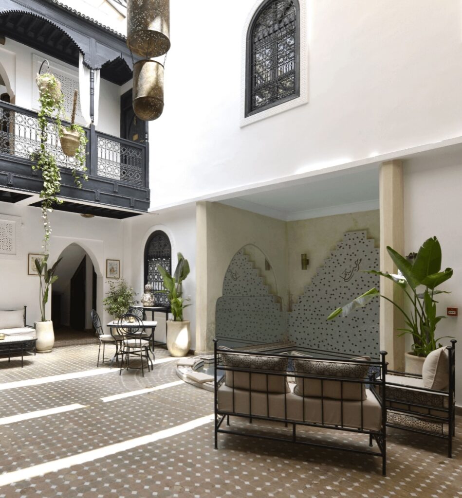 An ornate balcony frames the courtyard at Riad Zoraida, a highly-rated riad in the Marrakech medina