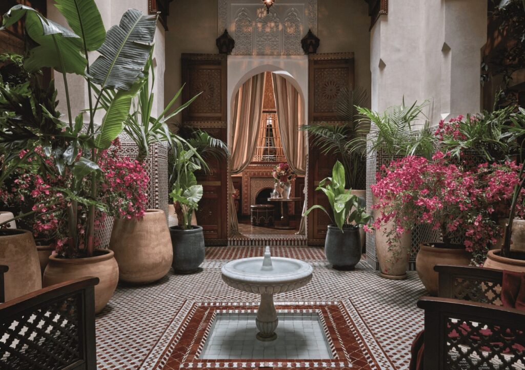 A fountain courtyard at one of the best luxury riads in Marrakech with a fireplace